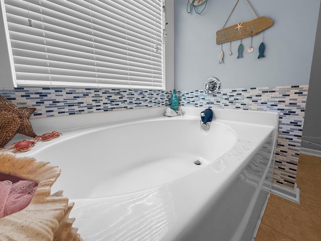 full bathroom with tile patterned flooring and a bath