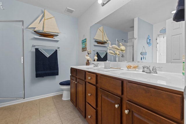 bathroom with a shower with door, double vanity, toilet, tile patterned flooring, and baseboards