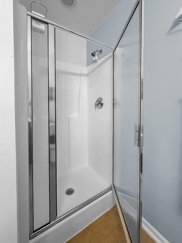 bathroom featuring a shower stall and tile patterned floors