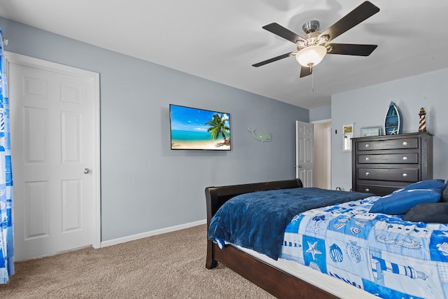 carpeted bedroom with baseboards and a ceiling fan