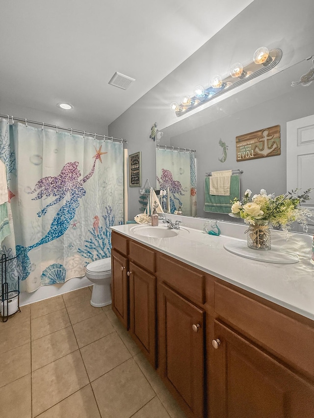 bathroom with tile patterned floors, toilet, vanity, and a shower with shower curtain