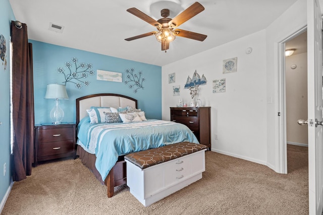bedroom with light colored carpet, a ceiling fan, and baseboards
