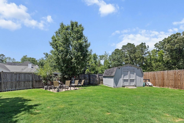view of yard with a shed, an outdoor structure, and a patio area