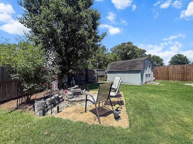 view of yard featuring an outdoor fire pit, a storage unit, a patio, and an outdoor structure