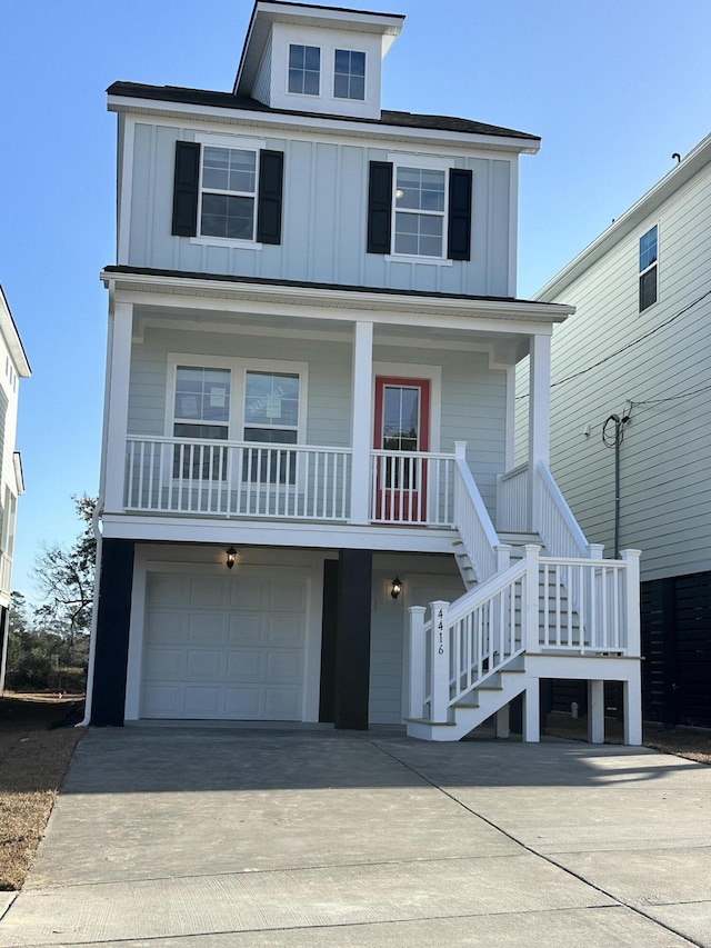 coastal inspired home featuring a porch and a garage