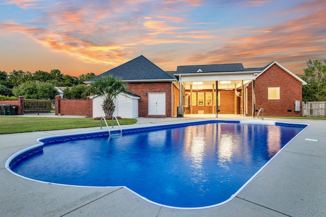 pool at dusk with a lawn