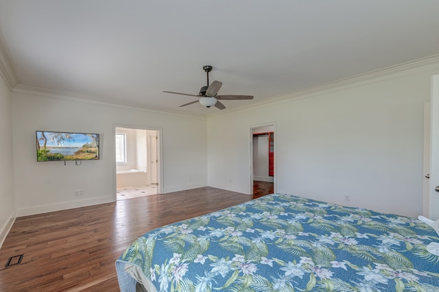 bedroom featuring ceiling fan, hardwood / wood-style flooring, ornamental molding, and ensuite bath