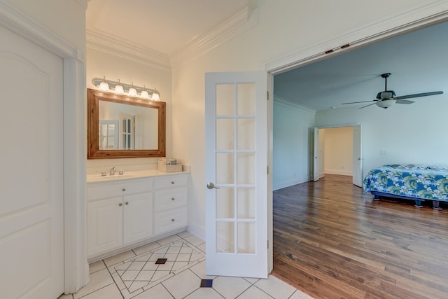 bathroom featuring crown molding, ceiling fan, vanity, and hardwood / wood-style flooring