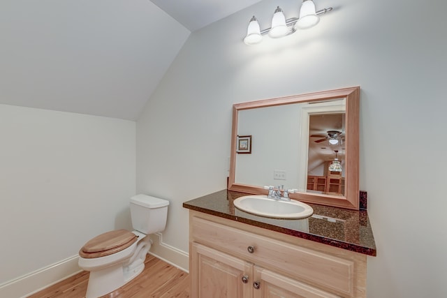 bathroom featuring lofted ceiling, vanity, toilet, and hardwood / wood-style flooring