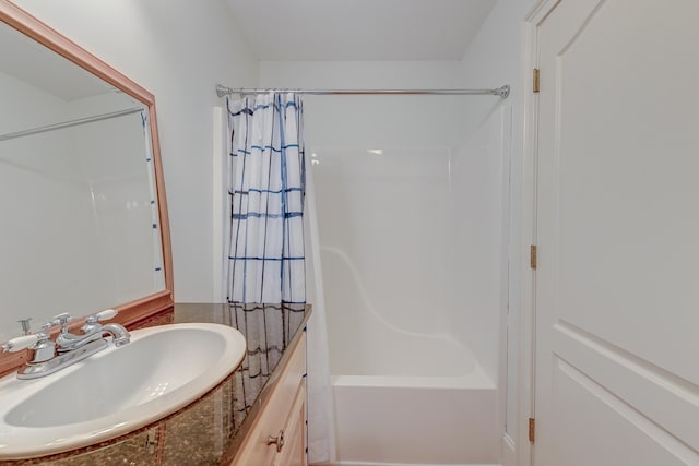 bathroom featuring vanity and shower / bathtub combination with curtain