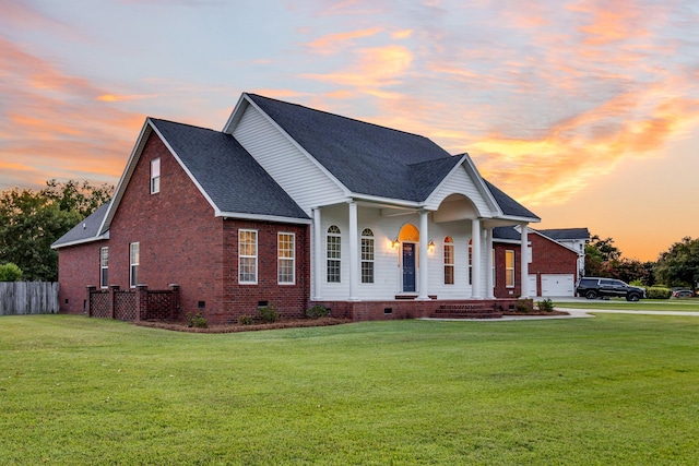 view of front of house with a garage and a lawn