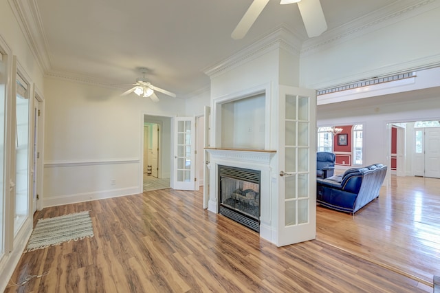 unfurnished living room featuring crown molding, ceiling fan, and light wood-type flooring