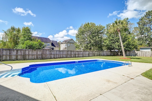 view of pool featuring a patio area and a yard