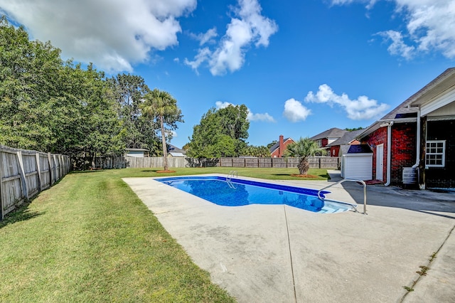 view of swimming pool with a lawn and a patio