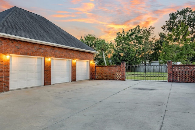 garage at dusk with a lawn