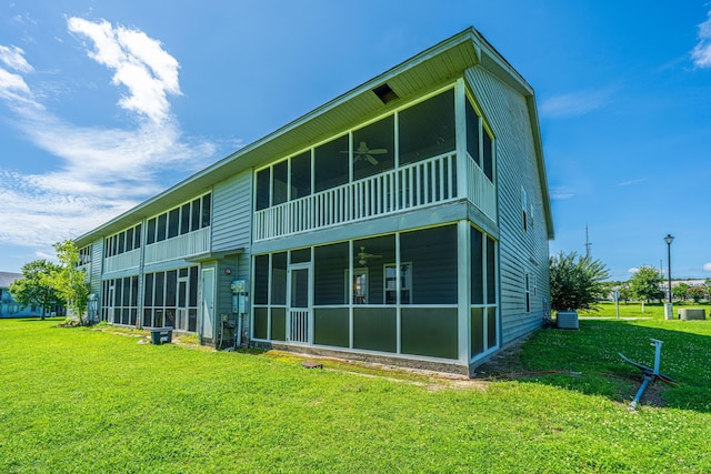 2601 Riverridge Ct Unit A, Moncks Corner, SC 29461 - rear view of house featuring a sunroom, a ceiling fan, and a yard