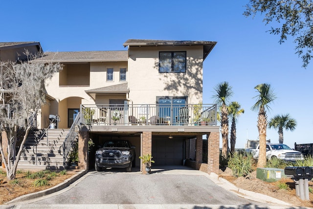 view of front of property featuring a garage and a carport