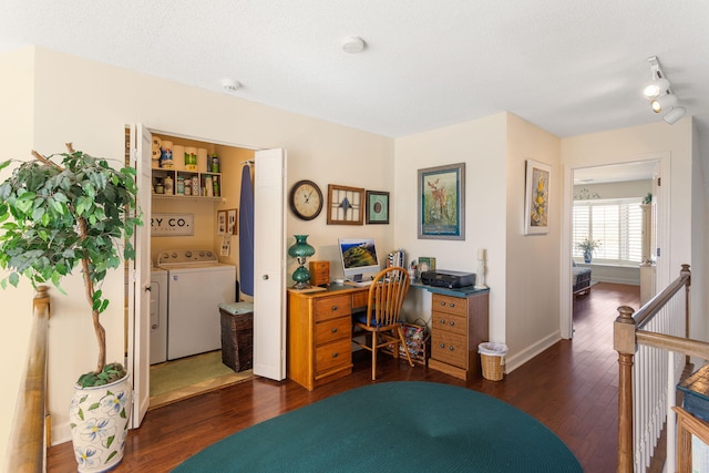 home office with a textured ceiling, washing machine and dryer, and dark wood-type flooring