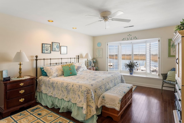 bedroom with ceiling fan and dark wood-type flooring