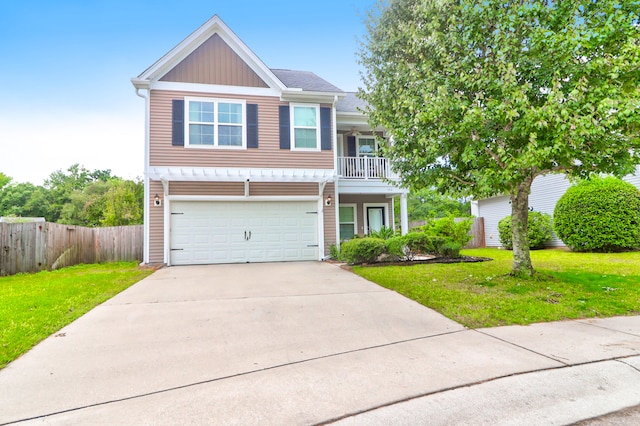 view of front of home featuring a balcony, a front yard, and a garage