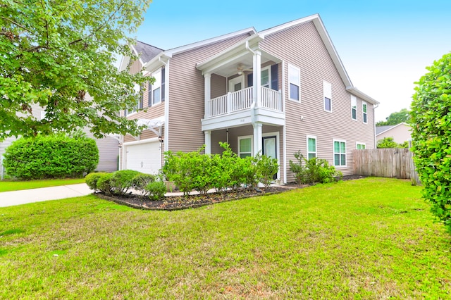 view of front of house featuring ceiling fan, a balcony, a front yard, and a garage