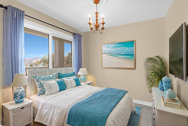 100 Mariners Cay Dr, Folly Beach, SC 29439 - bedroom featuring a chandelier, tile patterned floors, and baseboards