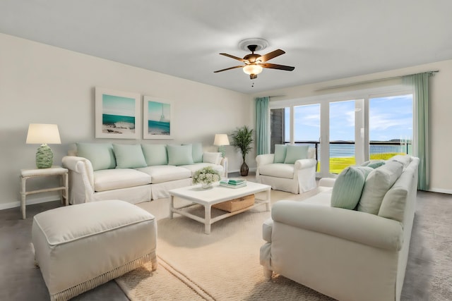 living room with a water view and ceiling fan