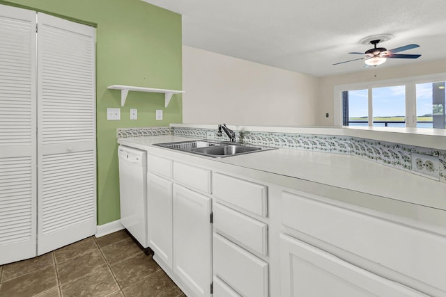 kitchen with dishwasher, white cabinets, sink, ceiling fan, and a water view