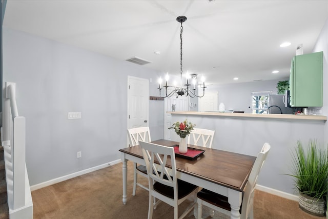 dining area with baseboards, carpet floors, and a notable chandelier