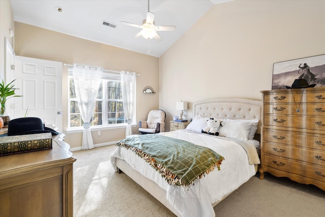 carpeted bedroom with lofted ceiling, a ceiling fan, visible vents, and baseboards