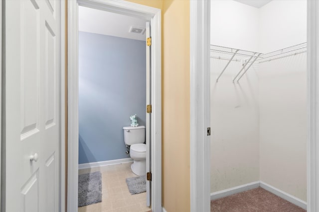 bathroom with visible vents, toilet, and baseboards