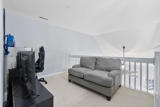 carpeted office space with vaulted ceiling, baseboards, and visible vents