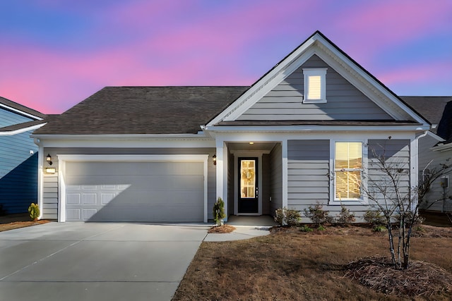 ranch-style house featuring a shingled roof, concrete driveway, and an attached garage