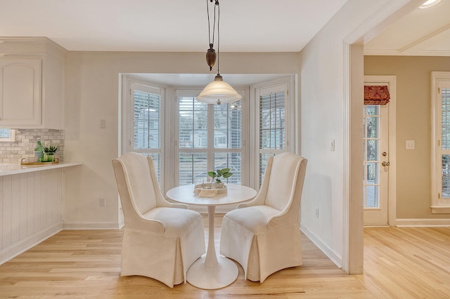 dining room featuring light wood-type flooring and baseboards