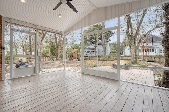 unfurnished sunroom featuring lofted ceiling, a healthy amount of sunlight, and ceiling fan