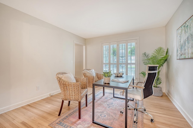 office area featuring light wood finished floors and baseboards