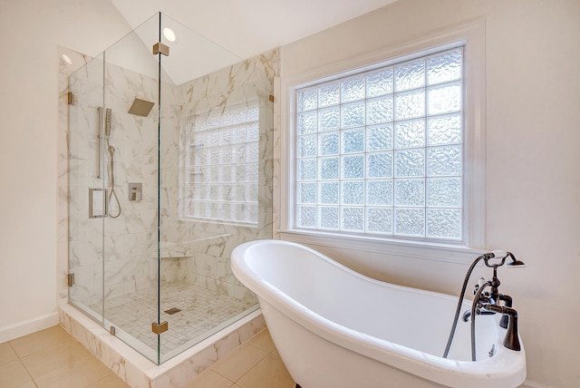 full bath with plenty of natural light, a marble finish shower, and tile patterned floors