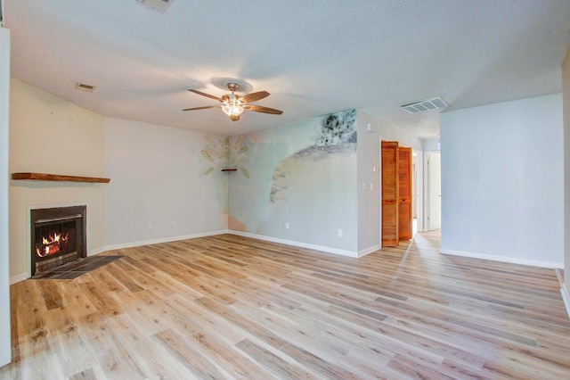 607 Waterwood Dr, Goose Creek, SC 29445 - unfurnished living room featuring visible vents, a ceiling fan, light wood-style flooring, and a fireplace with flush hearth