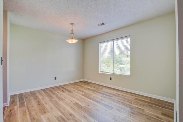 607 Waterwood Dr, Goose Creek, SC 29445 - empty room with visible vents, a textured ceiling, baseboards, and light wood-type flooring