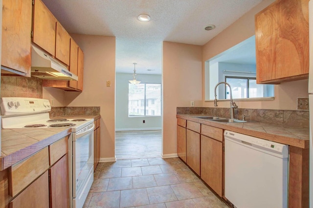 607 Waterwood Dr, Goose Creek, SC 29445 - kitchen with tile counters, a sink, under cabinet range hood, and white appliances