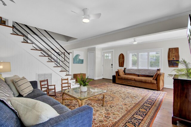 living room with crown molding, hardwood / wood-style floors, and ceiling fan