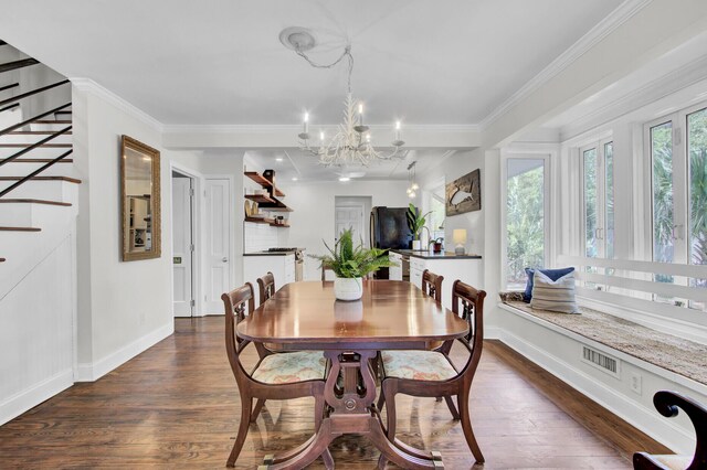 dining room featuring crown molding, dark hardwood / wood-style floors, and a chandelier