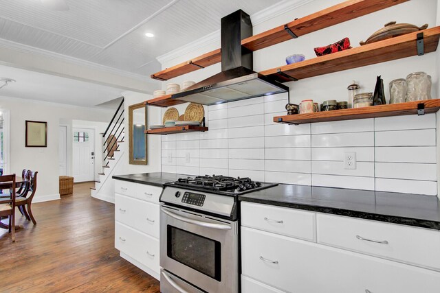 kitchen featuring gas range, wood-type flooring, backsplash, island range hood, and white cabinetry