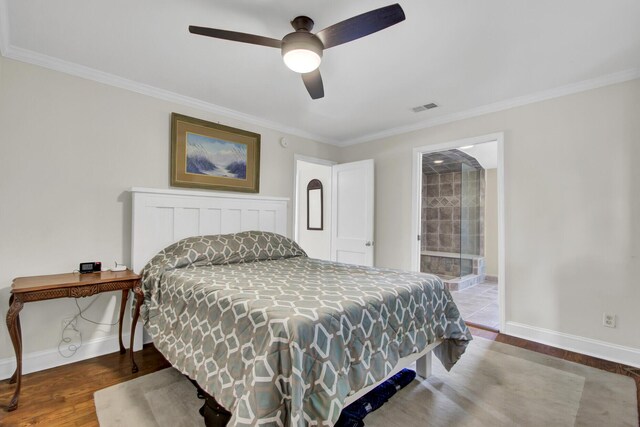 bedroom featuring ceiling fan, crown molding, ensuite bathroom, and wood-type flooring