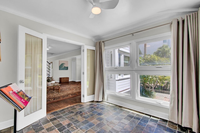 interior space with crown molding, dark wood-type flooring, plenty of natural light, and ceiling fan