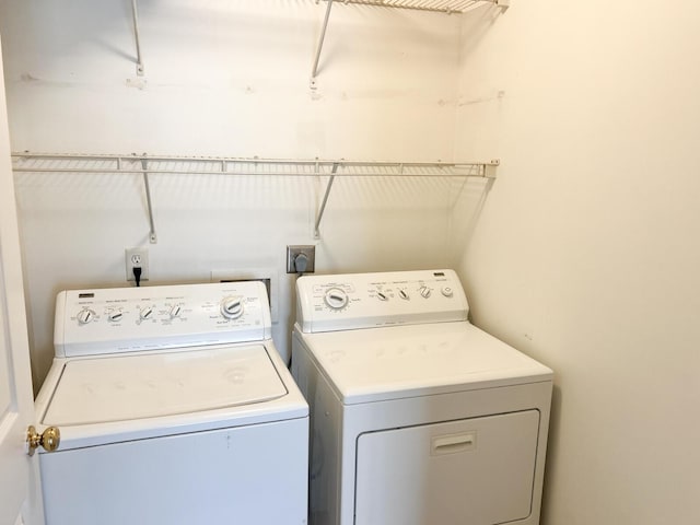clothes washing area featuring separate washer and dryer