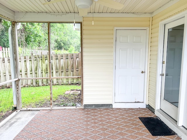 unfurnished sunroom with a ceiling fan