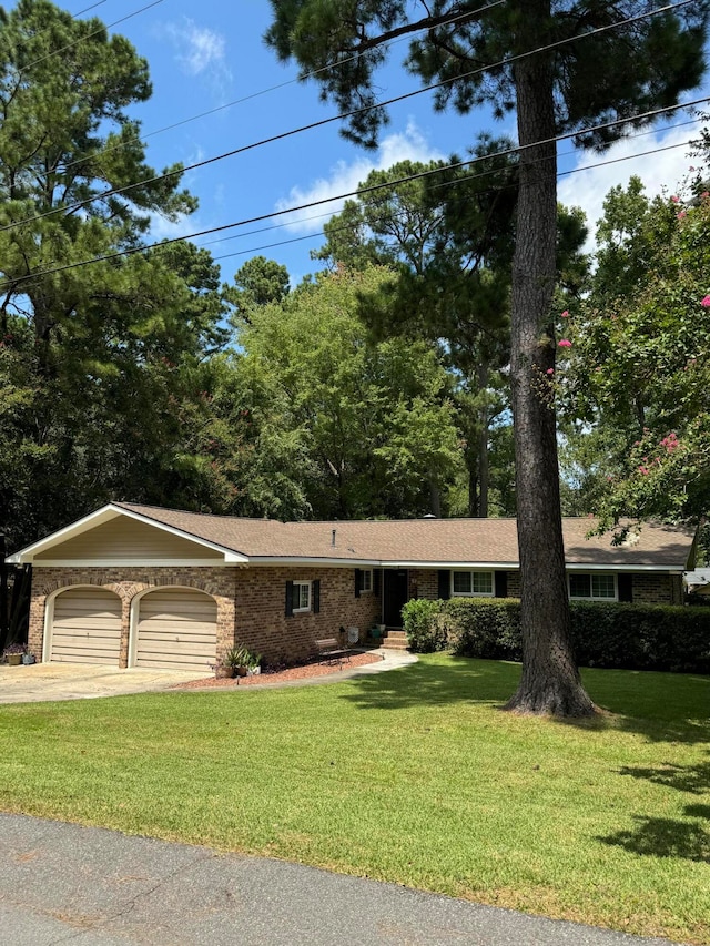 single story home featuring a garage and a front lawn