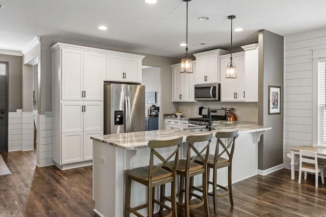 423 Sanctuary Park Dr, Summerville, SC 29486 - kitchen with stainless steel appliances, a peninsula, white cabinetry, a breakfast bar area, and recessed lighting