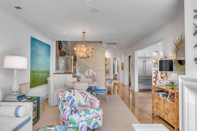 living room featuring an inviting chandelier and light wood-type flooring